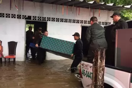 Policías ayudan a personas afectadas por las inundaciones.